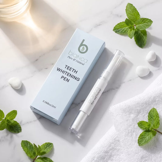 Bianca Pure Whitening Pen and its box on white marble with fresh mint leaves