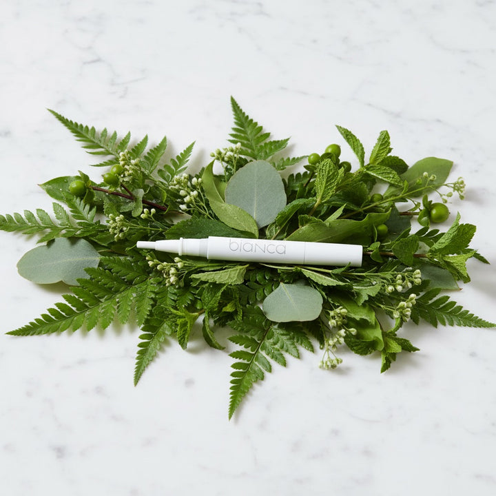 Bianca Bright natural whitening pen on green botanicals