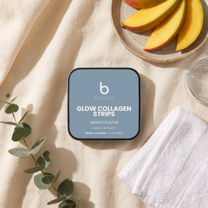 Bianca Glow Collagen Strips tin on cream linen with fresh mango slices and eucalyptus