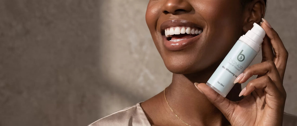 Smiling woman with radiant white teeth holding a bottle of Bianca Pure & Natural Max Whitening Gel in a luxury beauty editorial setting